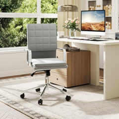 The office chair positioned in a bright room with a desk and computer monitor