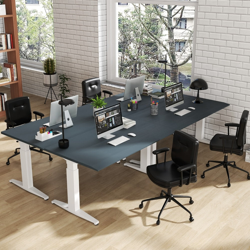 The office chair placed around a large shared desk in a modern open plan office environment