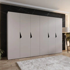 The hinged wardrobe in a light grey finish shown in a bedroom setting