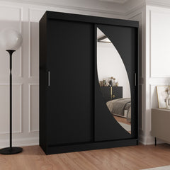 Milo Sliding Door Wardrobe 150cm in black standing in a modern bedroom with a floor lamp