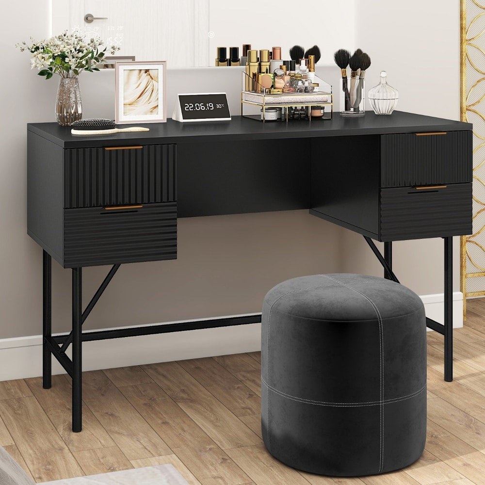 Black computer desk with drawers and storage, set up as a dressing table with makeup and stool