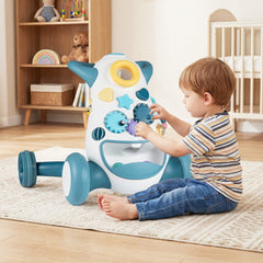 The baby walker being used by a young child sitting on a rug and playing with the activity gears