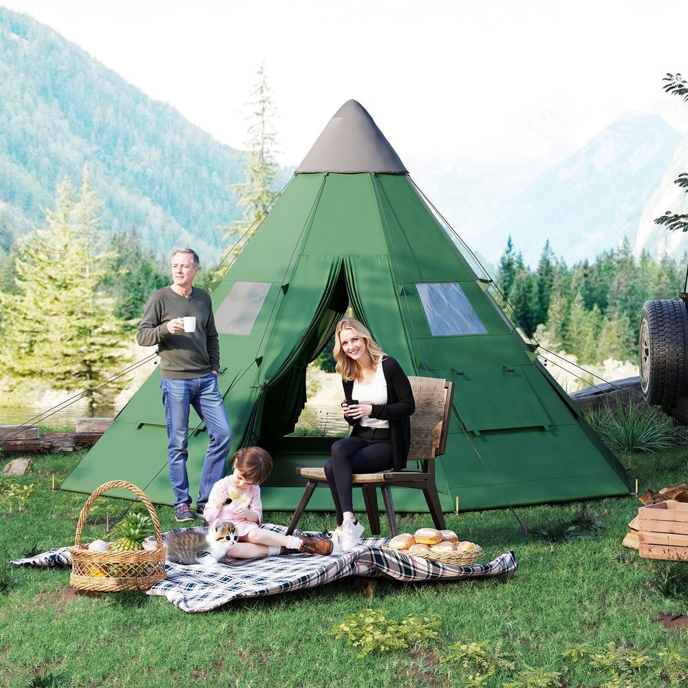 A family enjoying a picnic outside a green tipi tent in a natural setting