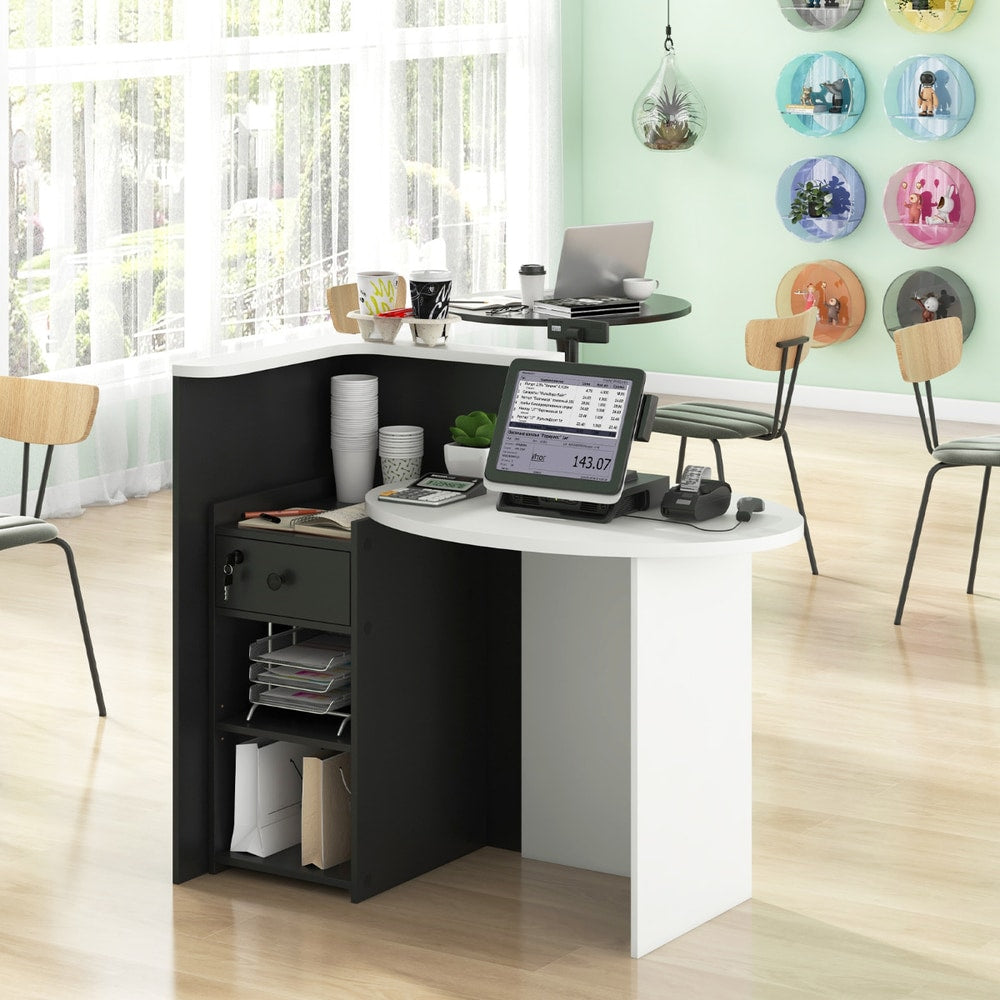 The reception counter desk set up for customer service with a till and coffee cups