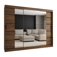 The sliding door wardrobe in a dark wood effect finish with mirrored centre doors reflecting a sofa