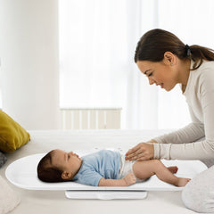 Smart Baby Scale with a mother holding her baby on it