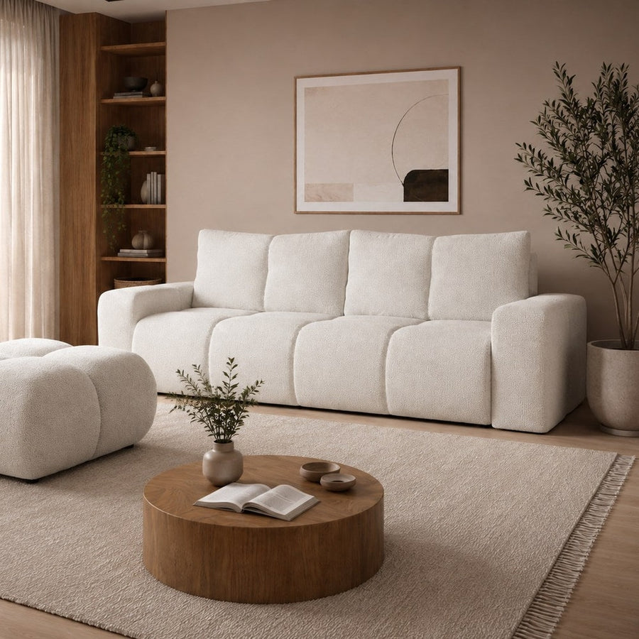 Sofa Bed Soho in a modern living room with a large round coffee table and a textured rug