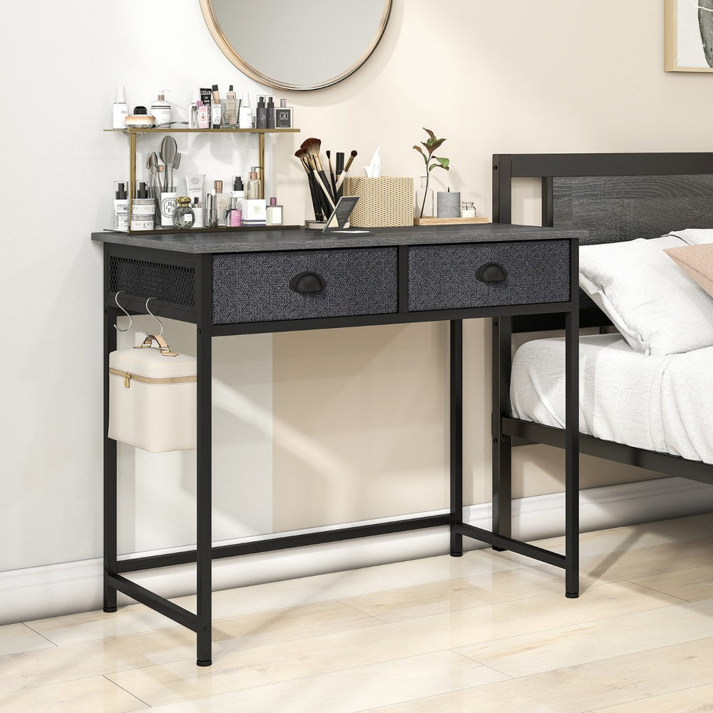 The office desk used as a dressing table in a bedroom with beauty products and a mirror