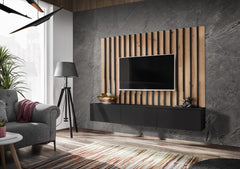 The entertainment unit in a black finish mounted against a dark stone effect wall