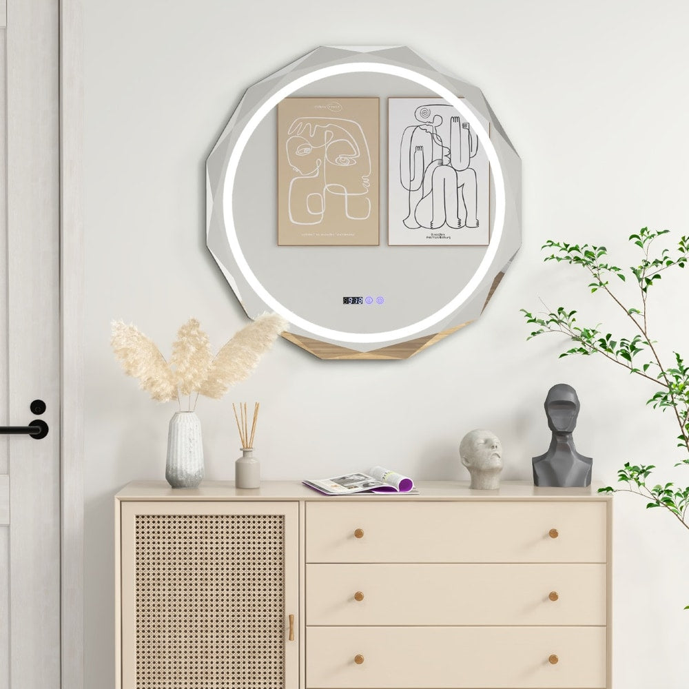 The decorative wall mirror hanging above a wooden chest of drawers in a bright living space