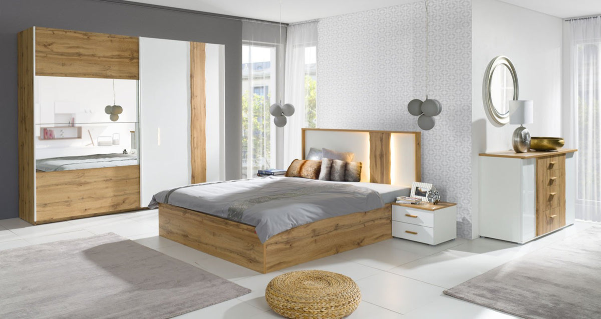 The sliding door wardrobe is shown in a modern bedroom setting with a bed and dresser