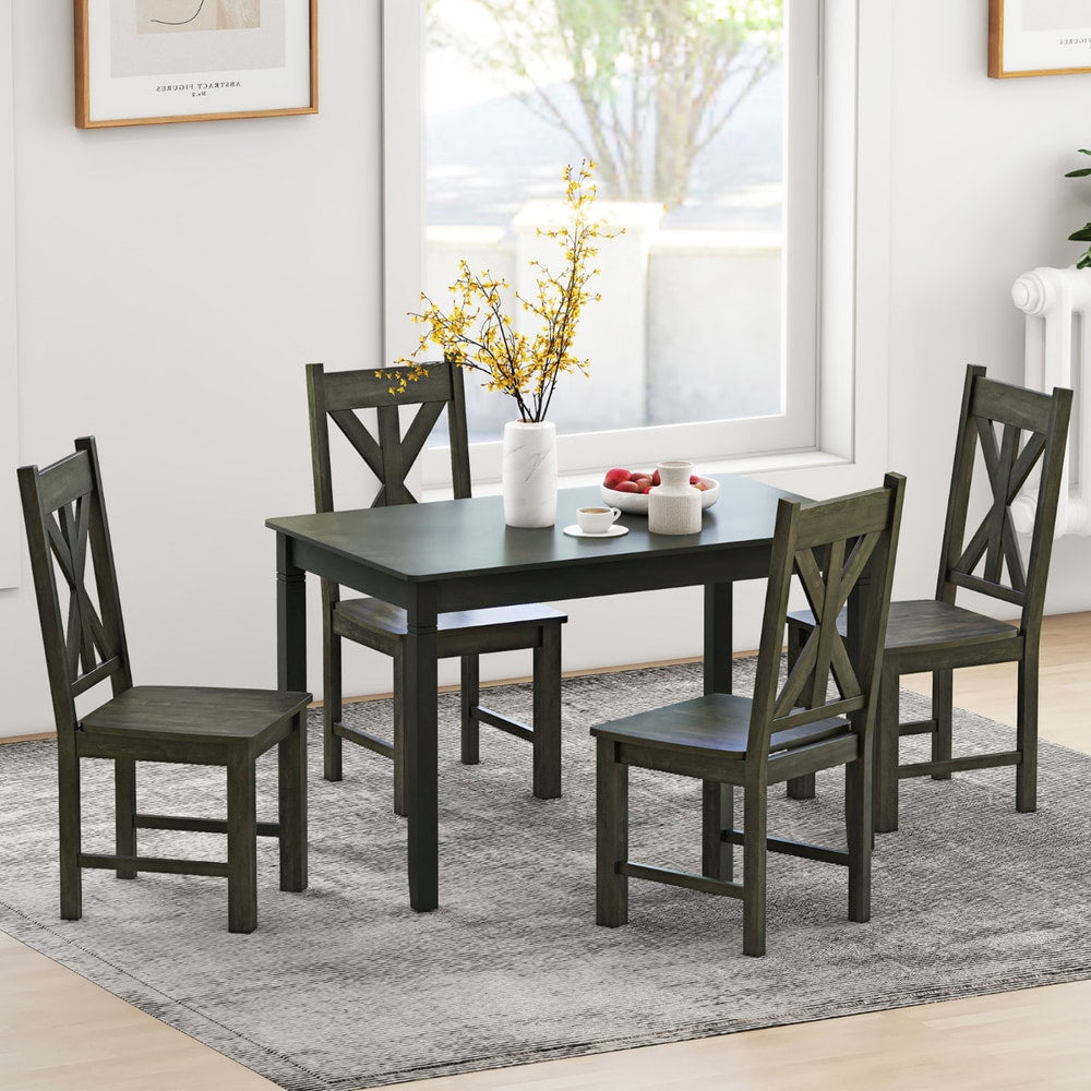 Four dining chairs around a table in a dining room setting