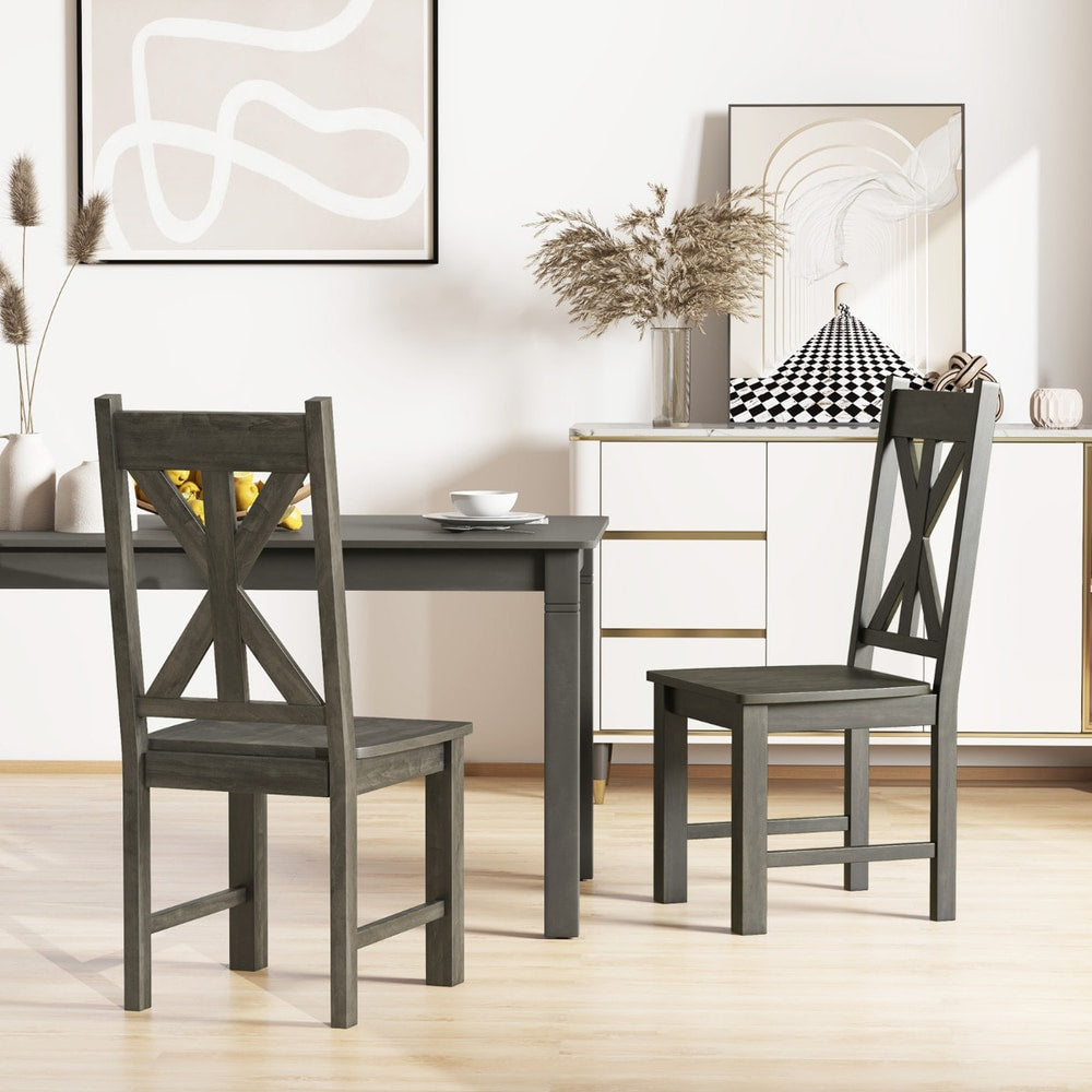 Two dining chairs in a dining room with a sideboard
