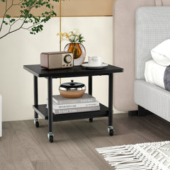 The black wooden printer stand with two tiers, shown next to a bed with a radio and books on it